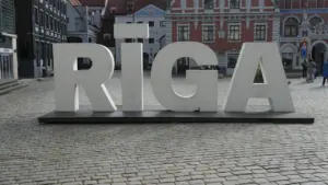 Liels uzraksts RĪGA uz bruģētas ielas vēsturiskā pilsētas centrā Rīgā.
