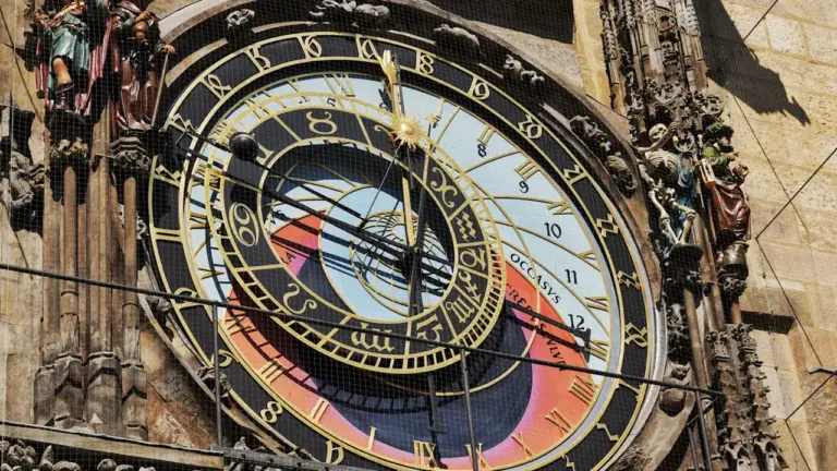 Sarežģīts un vēsturisks astronomiskais pulkstenis uz ēkas fasādes, kas simbolizē zodiaka laiku.